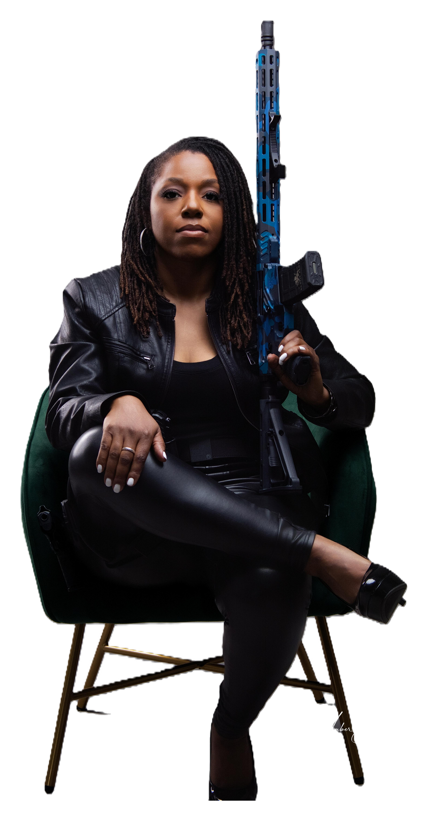 Cassandra seated in a commanding, empowered pose with a firearm — representing confidence, self-defense, and firearms training